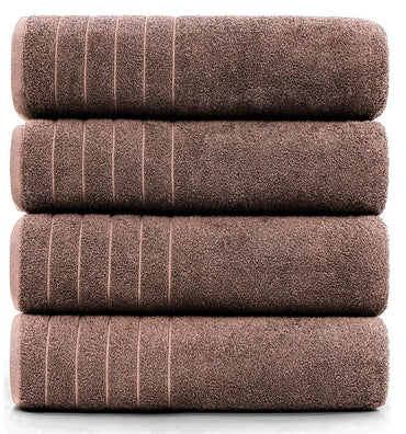 Premium cotton bath sheet used as a beach towel on sandy shore